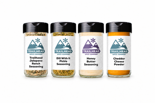 Family Movie Night Gift Set with Trailhead Jalapeno Ranch Seasoning, Dill With It Pickle Seasoning, Honey Butter Seasoning, Cheddar Cheese Powder jars side by side