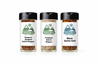 The Salt Box Gift Set with Outpost Smoked Salt & Pepper, Trailside Salt and Pepper Seasoning, Black Garlic Salt jars side by side
